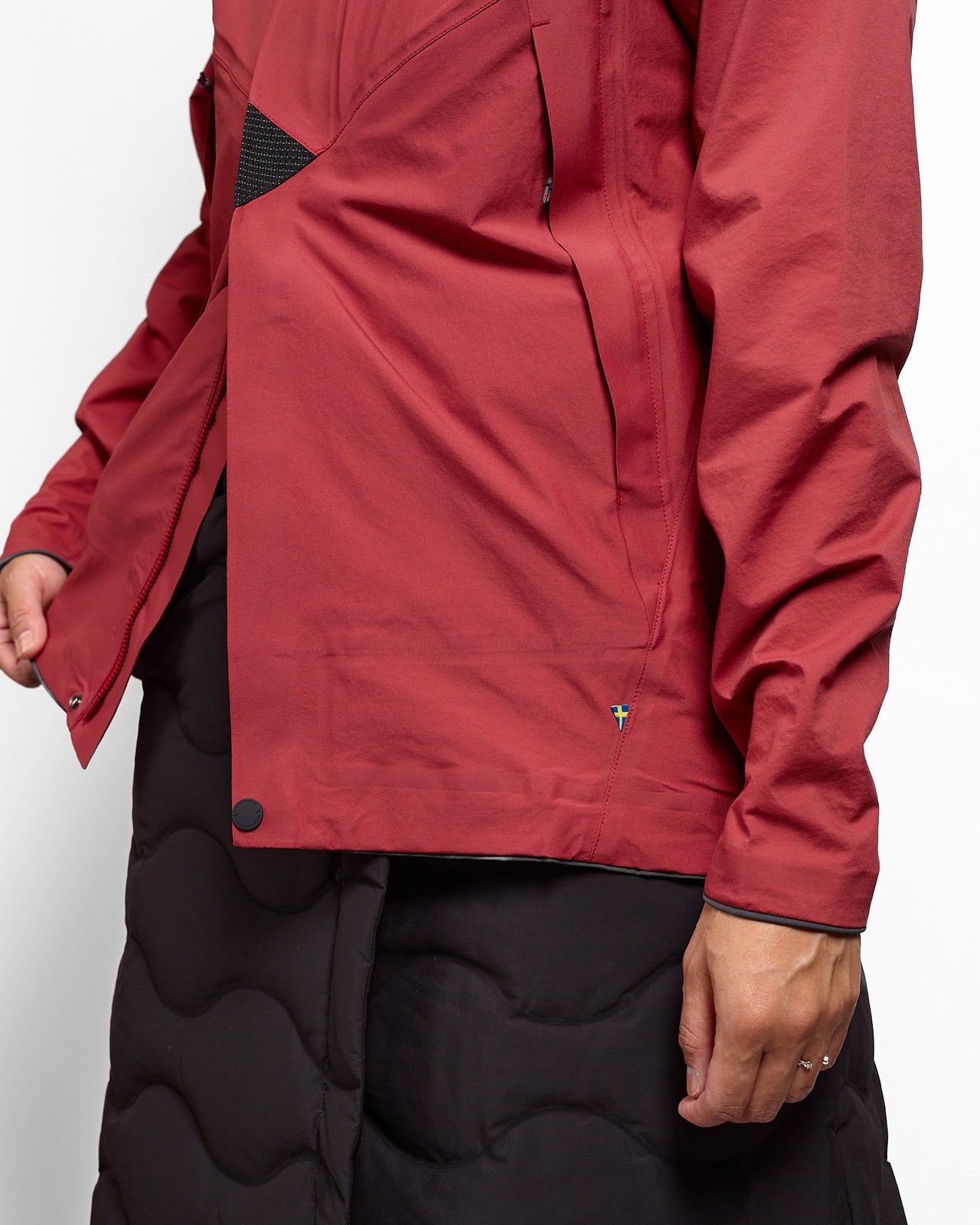 Red jacket with a brand logo on a plain background