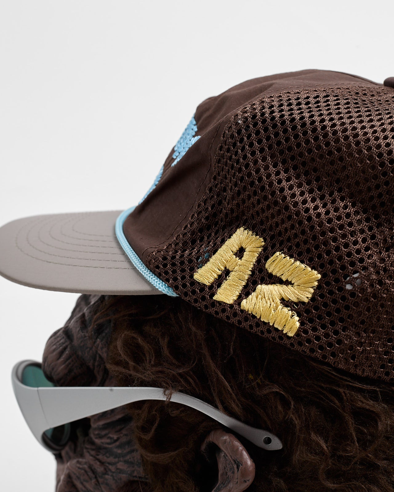 Running Rocks Trucker Hat in Brown